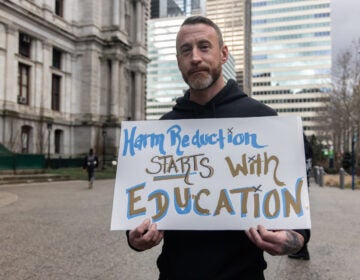 T.J. Erkert with harm reduction advocates at a rally outside City Hall