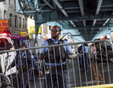 A police officer sets up a barricade on the street