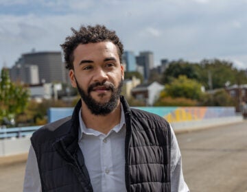 Branden Fletcher Dominguez poses for a photo in front of a road.