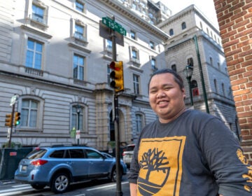 Paulo Garcia poses for a photo at a street corner