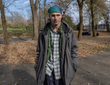 A young man poses for a photo outdoors