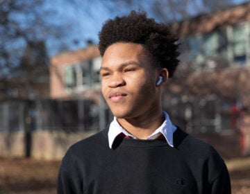 Joshua Scotland poses for a photo outside of Northeast High School