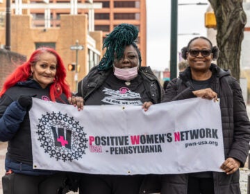 Maria Cookie Cruz (left), Kenya Moussa (center) co-chairs of PWN Pennsylvania, with Jeanette Murdock a PWN member who canvassed for overdose prevention centers in Philadelphia, outside the federal courthouse in Philadelphia on December 4, 2023. (Kimberly Paynter/WHYY)