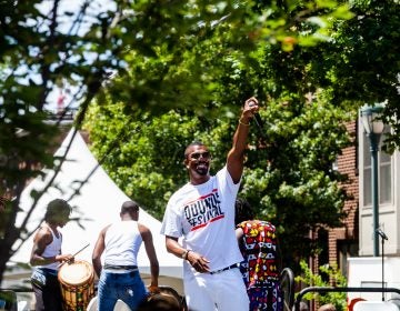 Host of the Odunde Festival Six King hypes up the crowd on South Street Sunday during the festival celebrating African and Carribean culture. (Brad Larrison for WHYY)