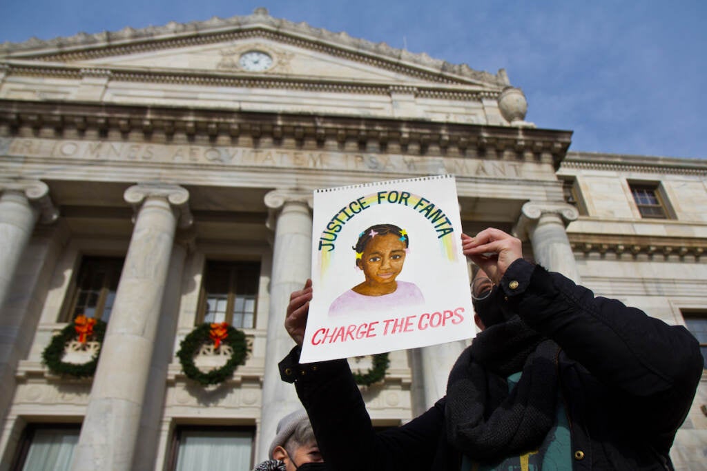 Protester holding a picture of Fanta Bility