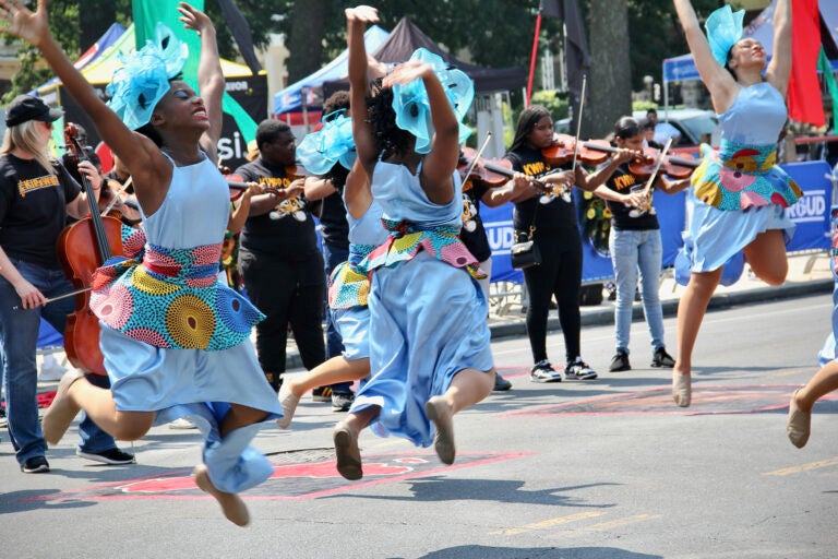 Dancers and musicians on the street during a parade