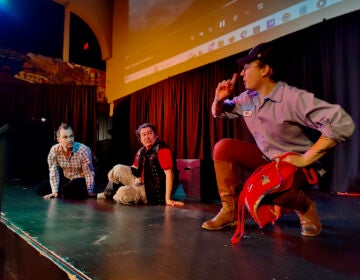 Dance troupe members rehearse onstage.