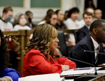 Jamie Gauthier sits in front of a microphone