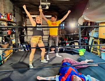 Jerry Kaba helps Jett Biggert choreograph their victory inside a practice ring before AWFUL Wrestling stages its MocaMania event. (Peter Crimmins/WHYY)