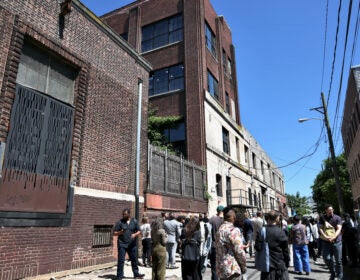 People walk the sidewalk off North American Street