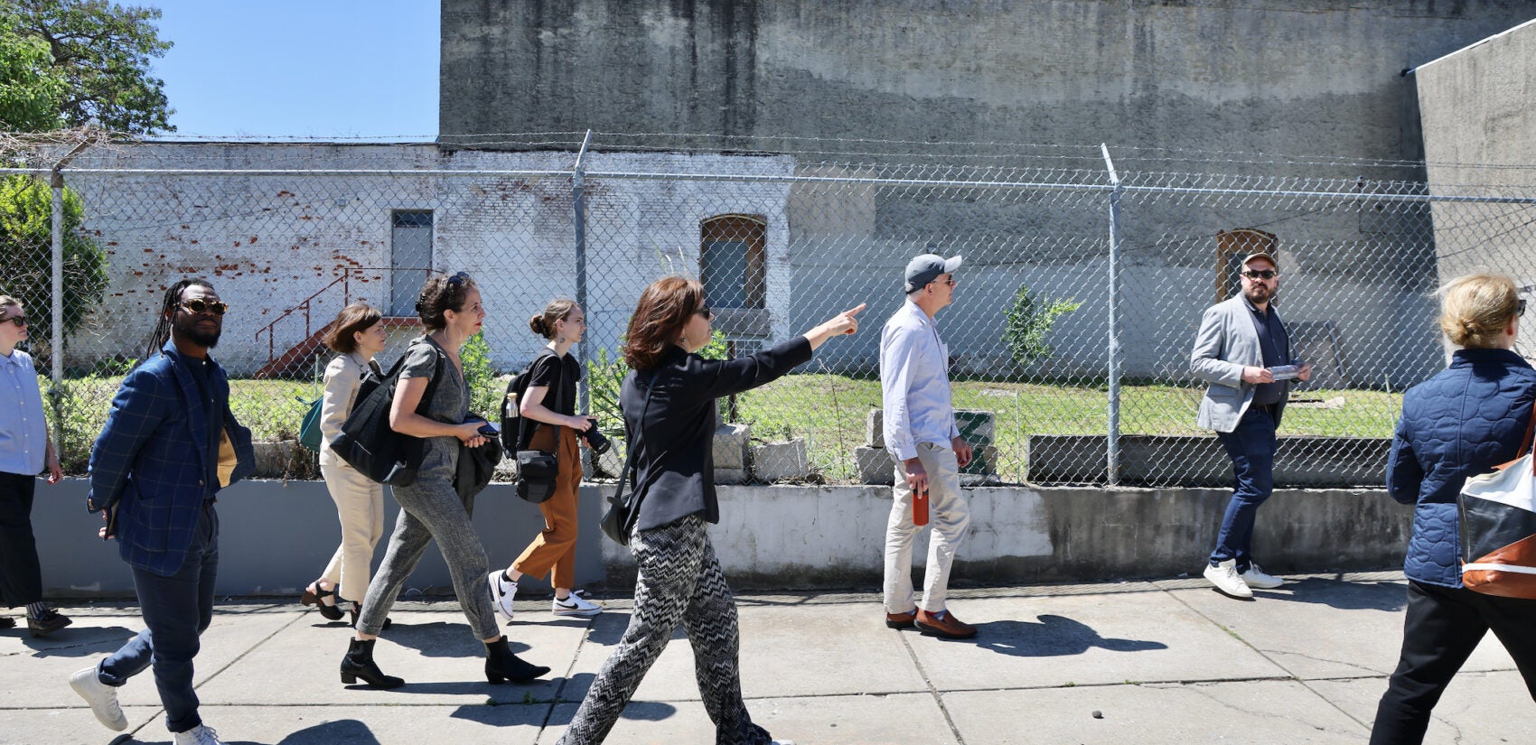 Jennifer Rice leads a tour on the sidewalk