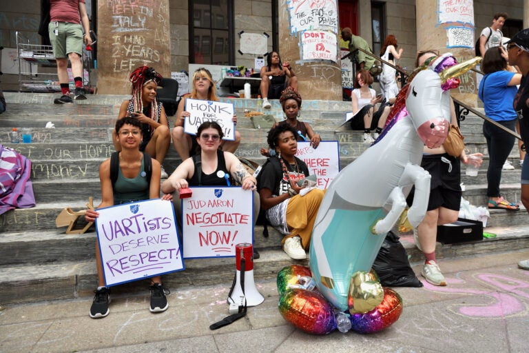 Students gather with signs on the steps of Hamilton Hall