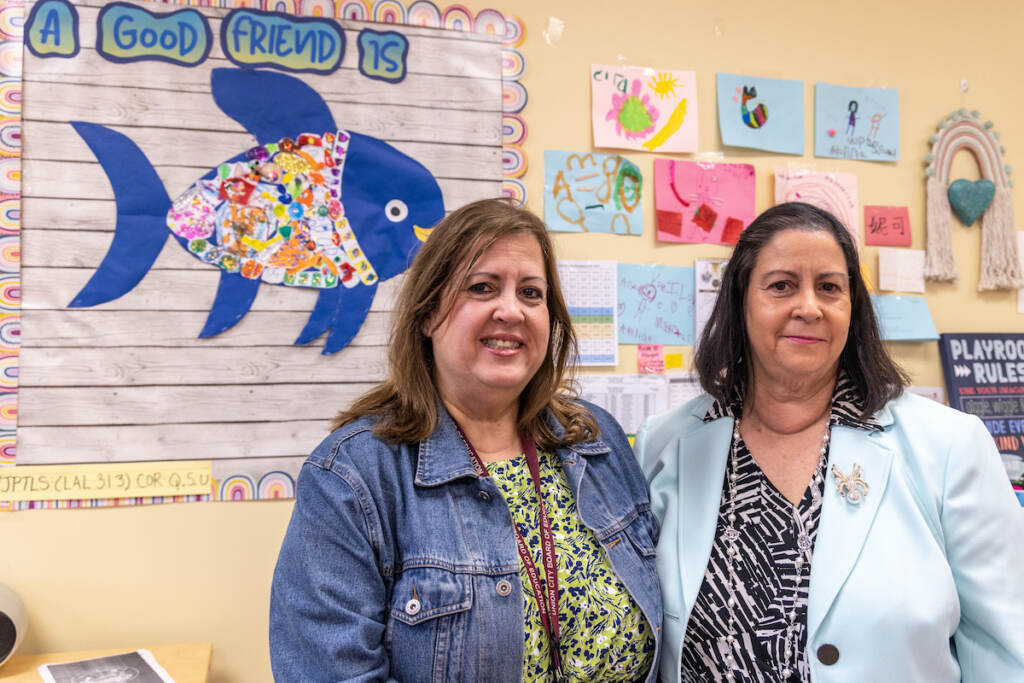 Adriana Birne and Silvia Abbato posing in a classroom.