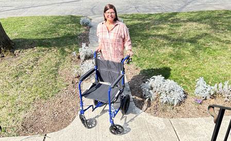 A woman standing with a walker