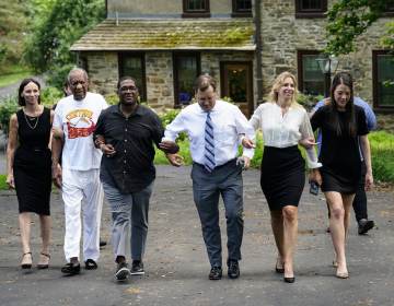 Bill Cosby, second left, and spokesperson Andrew Wyatt, third left, approach members of the media gathered outside Cosby's home in Elkins Park, Pa., Wednesday, June 30, 2021, after Pennsylvania's highest court overturned his sex assault conviction. (AP Photo/Matt Rourke)