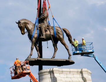 Crews remove one of the country's largest remaining monuments to the Confederacy, a towering statue of Confederate General Robert E. Lee on Monument Avenue in Richmond, Va., Wednesday, Sept. 8, 2021. (AP Photo/Steve Helber, File)