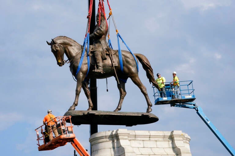 Crews remove one of the country's largest remaining monuments to the Confederacy, a towering statue of Confederate General Robert E. Lee on Monument Avenue in Richmond, Va., Wednesday, Sept. 8, 2021. (AP Photo/Steve Helber, File)