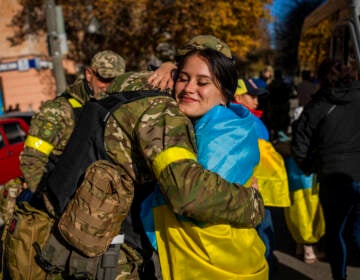 A Kherson resident hugs a Ukrainian defence force member in Kherson, southern Ukraine, Monday, Nov. 14, 2022. The retaking of Kherson was one of Ukraine's biggest successes in the nearly nine months since Moscow's invasion. (AP Photo/Bernat Armangue)