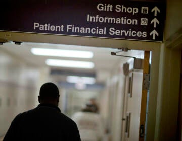 A sign points visitors toward the financial services department at a hospital.