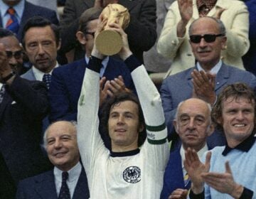 West Germany captain Franz Beckenbauer holds up the World Cup trophy after his team defeated the Netherlands by 2-1, in the World Cup soccer final at Munich's Olympic stadium, in West Germany, on Jul. 7, 1974. German soccer great Franz Beckenbauer has died at 78, news agency dpa reports.