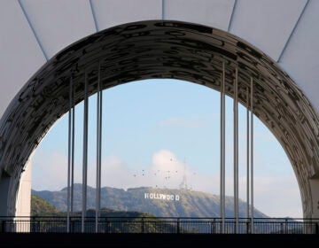 Hollywood sign visible in the distance through a theater window