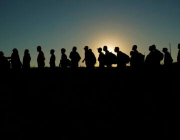 FILE - Migrants who crossed the Rio Grande and entered the U.S. from Mexico are lined up for processing by U.S. Customs and Border Protection, Sept. 23, 2023, in Eagle Pass, Texas. A divided Supreme Court on Tuesday, March 19, 2024, lifted a stay on a Texas law that gives police broad powers to arrest migrants suspected of crossing the border illegally, while a legal battle over immigration authority plays out. (AP Photo/Eric Gay, File)