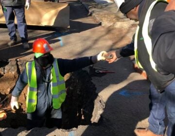 workers replacing lead water pipes in the ground