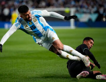 Argentina's Nicolas Gonzalez, left, collides with El Salvador's Melvin Cruz during the first half of a friendly soccer match