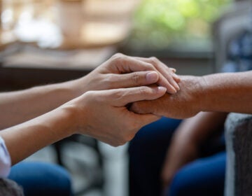 Two people holding hands