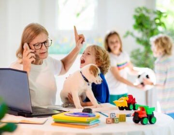 Mother working from home with kids.(Bigstock/famveldman)