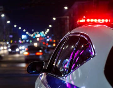 Police car with siren flashing.