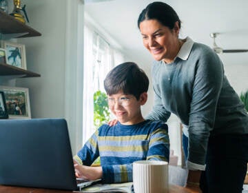 Mother and son looking at a laptop together