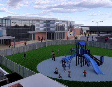 A rendering of a building with a playground in front of it.