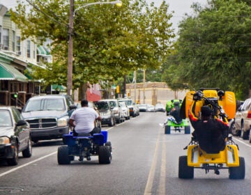 Young people riding ATVs through the streets of Philly. (Kimberly Painter/WHYY)