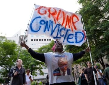 A demonstrator reacts to the guilty verdict announced against former President Donald Trump outside Manhattan Criminal Court