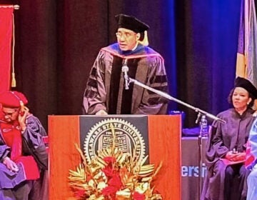 Andrew Holness speaking at a podium at the graduation