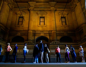 Voters wait in line to make corrections to their ballots at City Hall