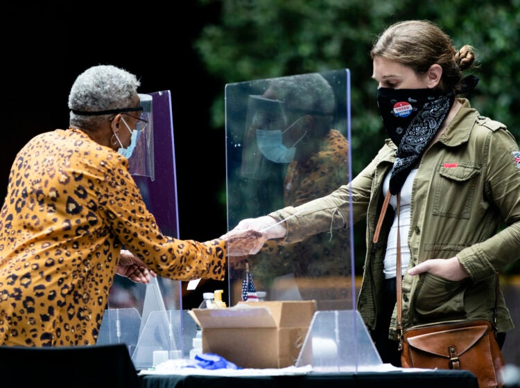 voter hands in her ballot