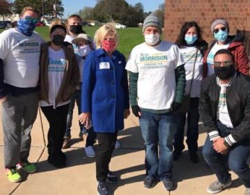 Eric Morrison appears with supporters outside a polling location on Election Day.