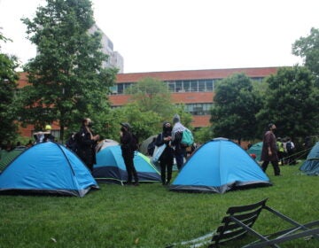 Hundreds of Pro-Palestinian protesters marched from City Hall toward University City on Saturday. They linked arms and encircled a group of people setting up tents on Drexel University's campus.