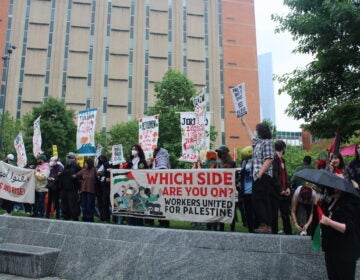 Hundreds of pro-Palestinian protesters marched from City Hall toward University City on Saturday. They linked arms and encircled a group of people setting up tents on Drexel University's campus. (Emily Neil/WHYY News)