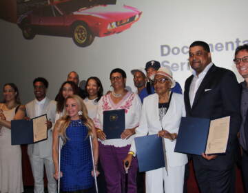 City Representative Sheila Hess, members of Chamberlain's family, and people who worked on Goliath pose for a group photo