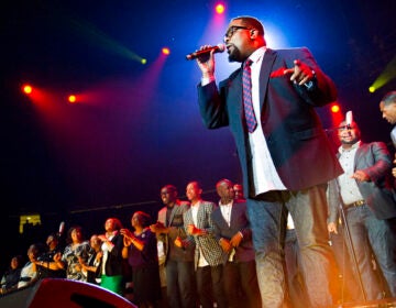 Hezekiah Walker sings with a group onstage