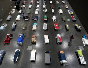 Beds fill a homeless shelter inside a convention center