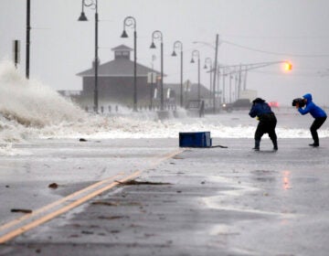 people photograph wet weather as the hurricane arrives