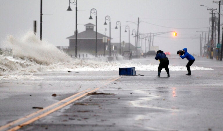 people photograph wet weather as the hurricane arrives