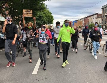 Black Lives Matter protesters led by Romel Clark (center) march through Fishtown on June 2, 2020. (Layla A. Jones/WHYY)