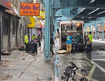 Crews are seen cleaning up a street in Kensington.