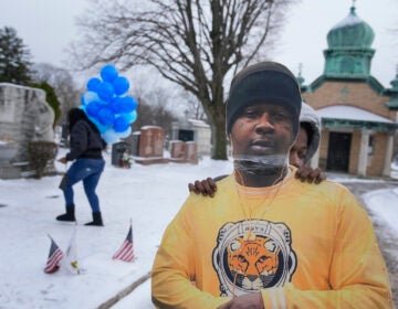 Timere Jones, right, carries a life-sized picture of his brother, Jameek Lowery