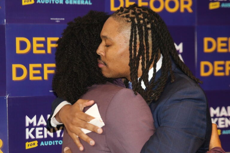 Malcolm Kenyatta and his husband Matthew embrace after his victory